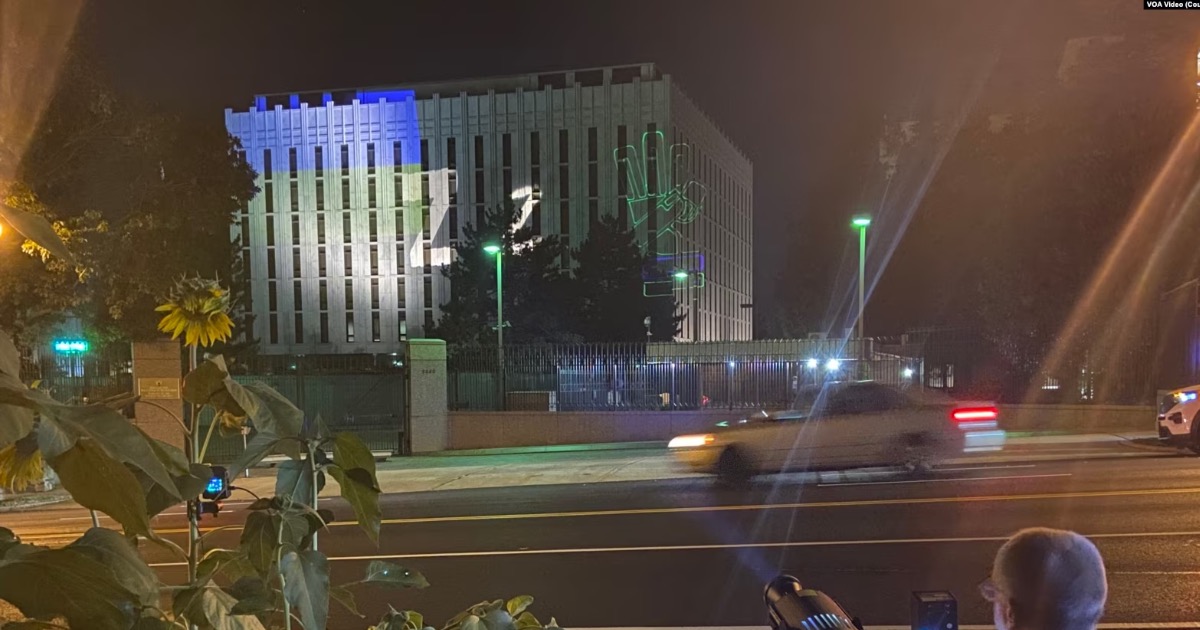 US journalist Benjamin Wittes projects the Ukrainian flag and works by Ukrainian artist Nikita Titov on the walls of the Russian Embassy in Washington, DC